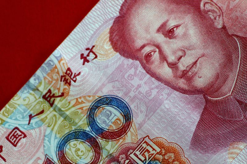 © Reuters. FILE PHOTO: A China yuan note is seen in this illustration photo May 31, 2017. REUTERS/Thomas White/Illustration/File Photo